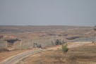 FILE - Israeli army bulldozers are seen near the Gaza Strip border, in southern Israel, Thursday, June 13, 2024.  Israel's military said Saturday, Jun
