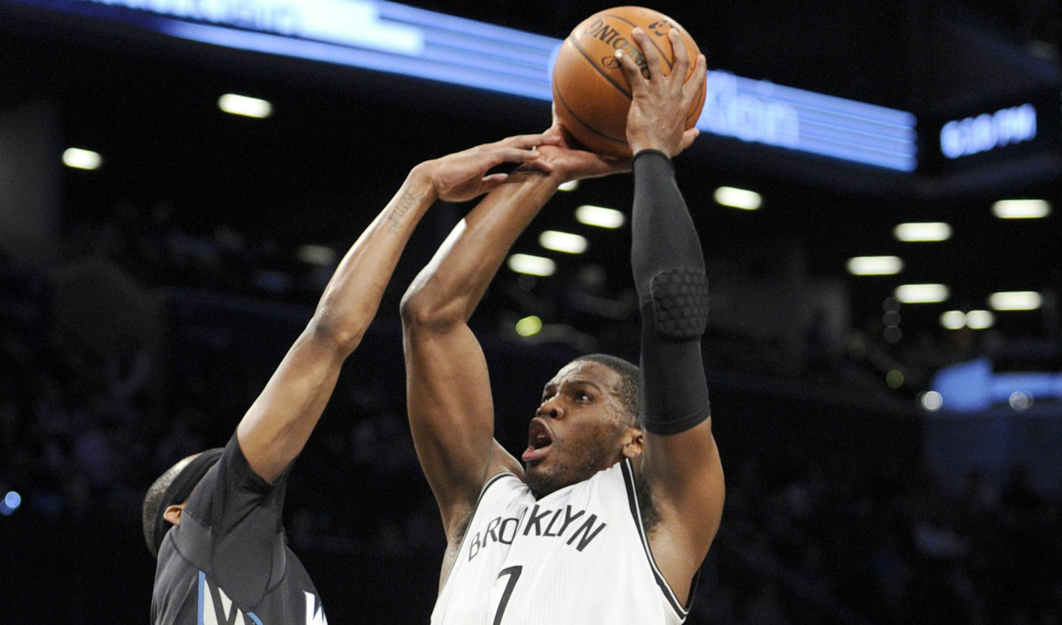Brooklyn's Joe Johnson was fouled by the Wolves' Corey Brewer while driving to the basket Sunday.