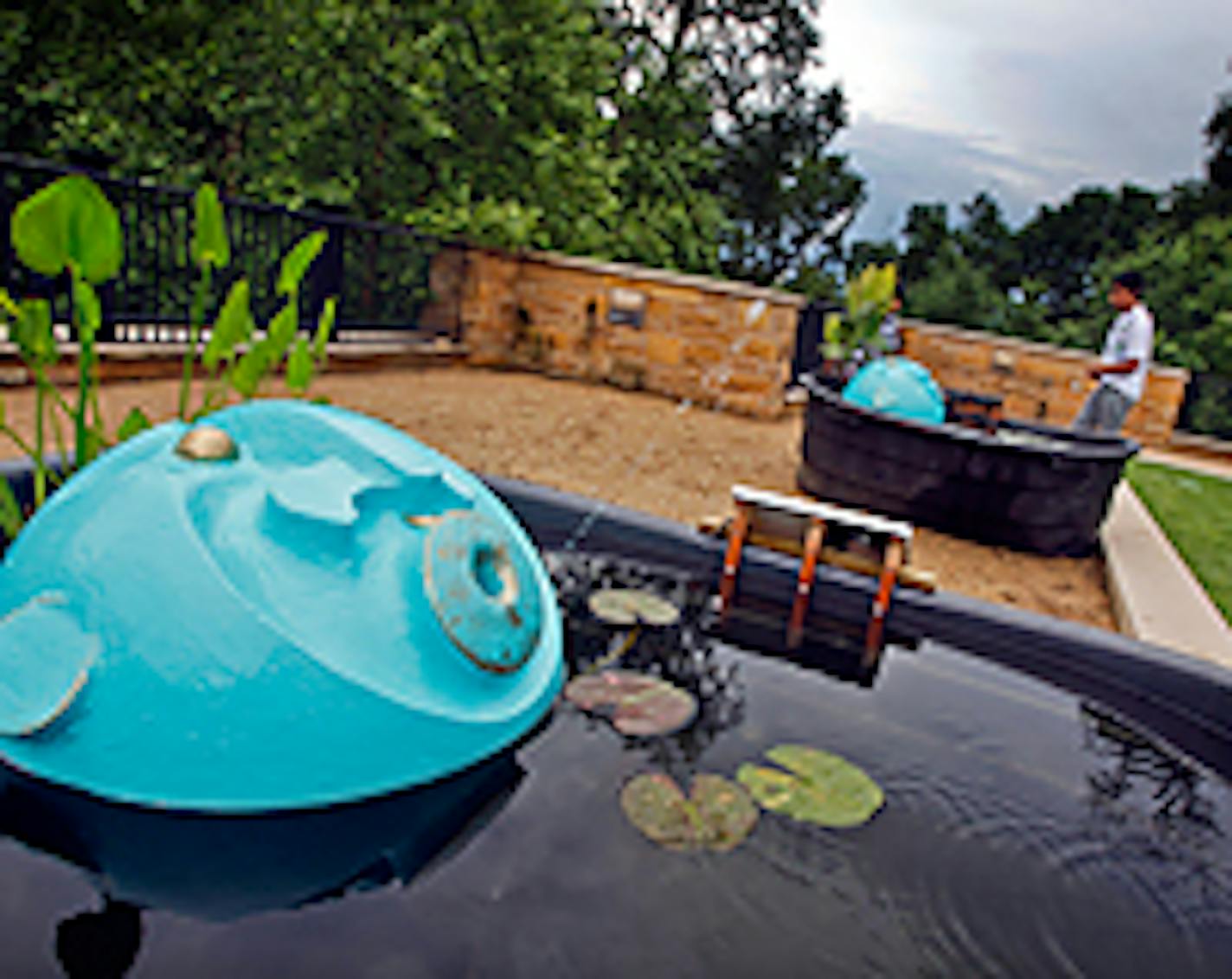 Water flies from the mouth of a sculpture in Solar Spitters by artist Marjorie Pitz