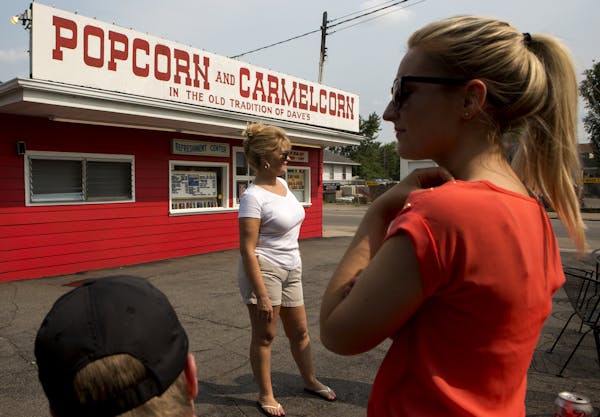 Sherri Shannon-Neary, center, owner of Dave&#x2019;s Popcorn, waited for customers with her daughter Olivia Neary, right, and Ben Boldenow.