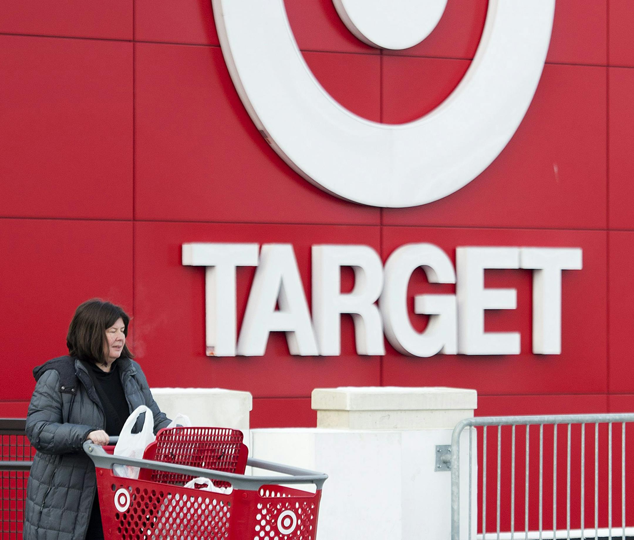 Shopper Laura Steele leaves a Target store in Toronto on Thursday, Jan. 15, 2015. More than 17,600 Target employees will eventually lose their jobs when the U.S. discount retailer closes its 133 Canadian stores after only about two years to end financial losses that went as high as a billion dollars a year. (AP Photo/The Canadian Press, Nathan Denette) ORG XMIT: MIN2015011510510343