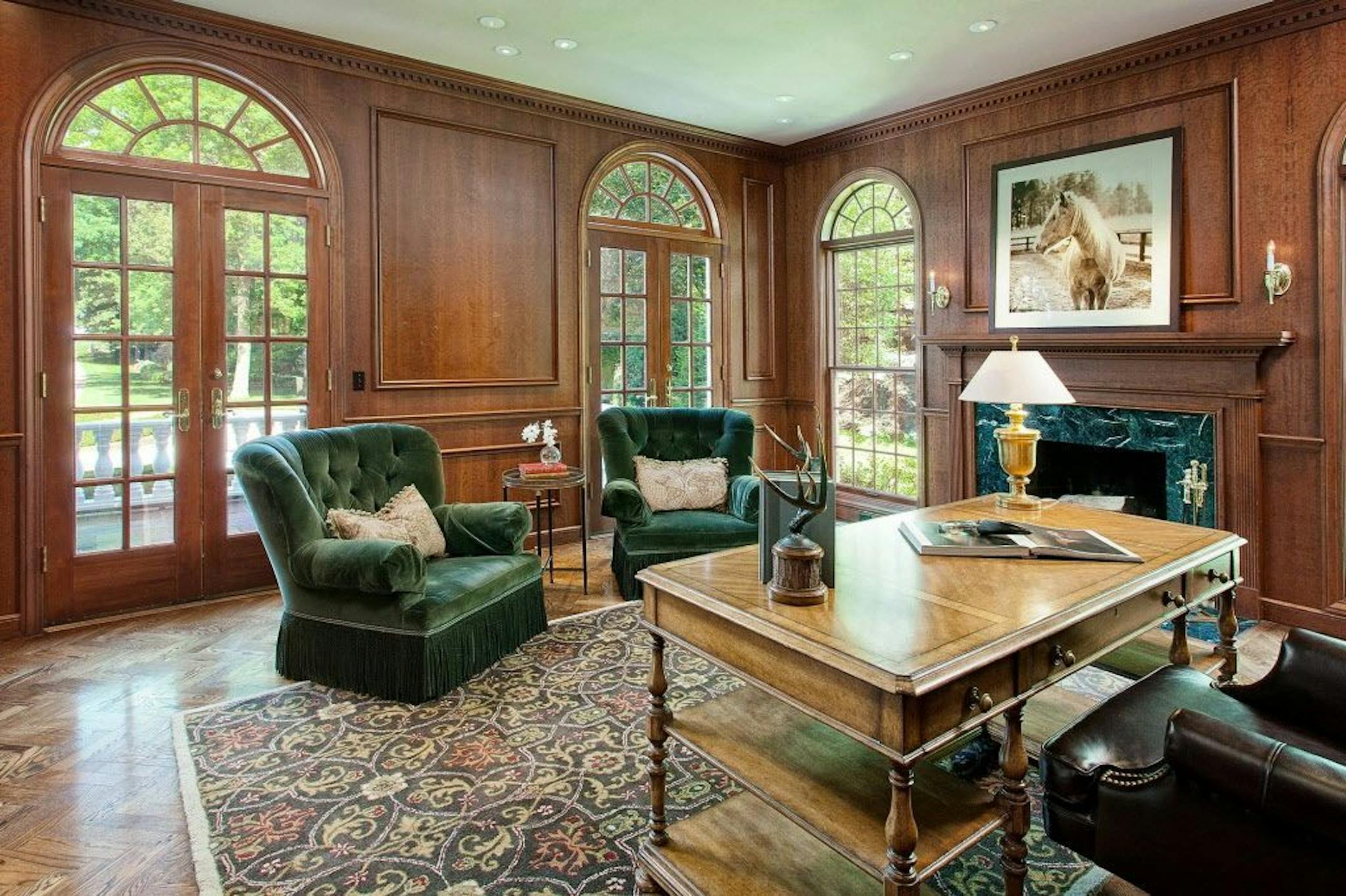 The library has a wood-burning fireplace on the far wall.