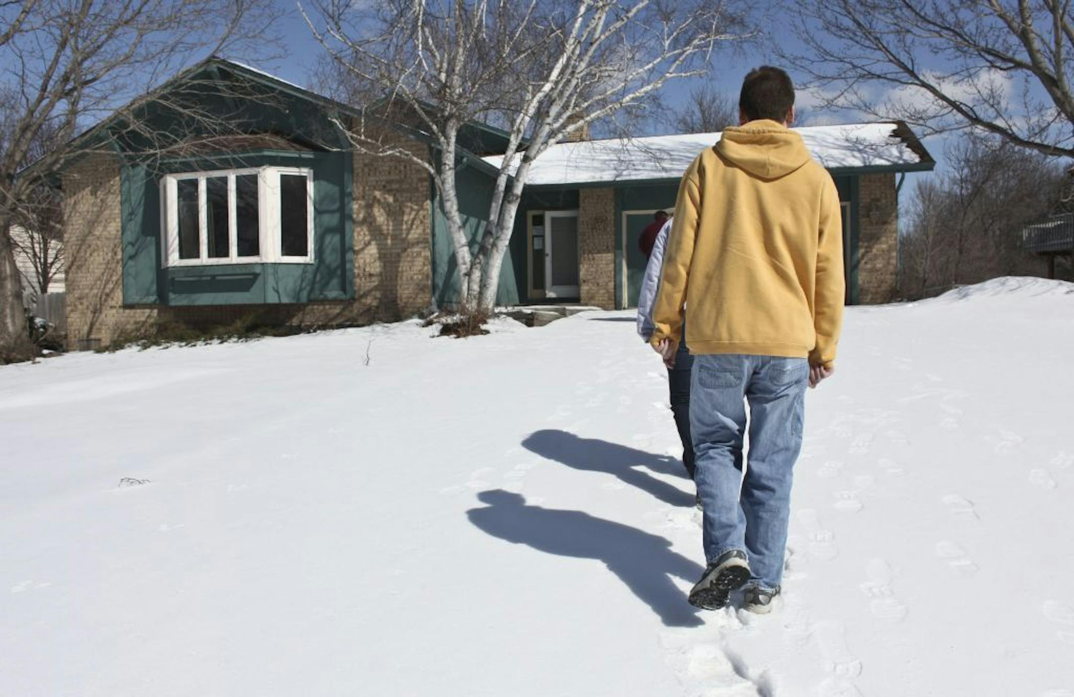 Ryan Loeck along with his wife Kristi and Realtor Aaron Dickinson walked up to a house for sale in Plymouth.