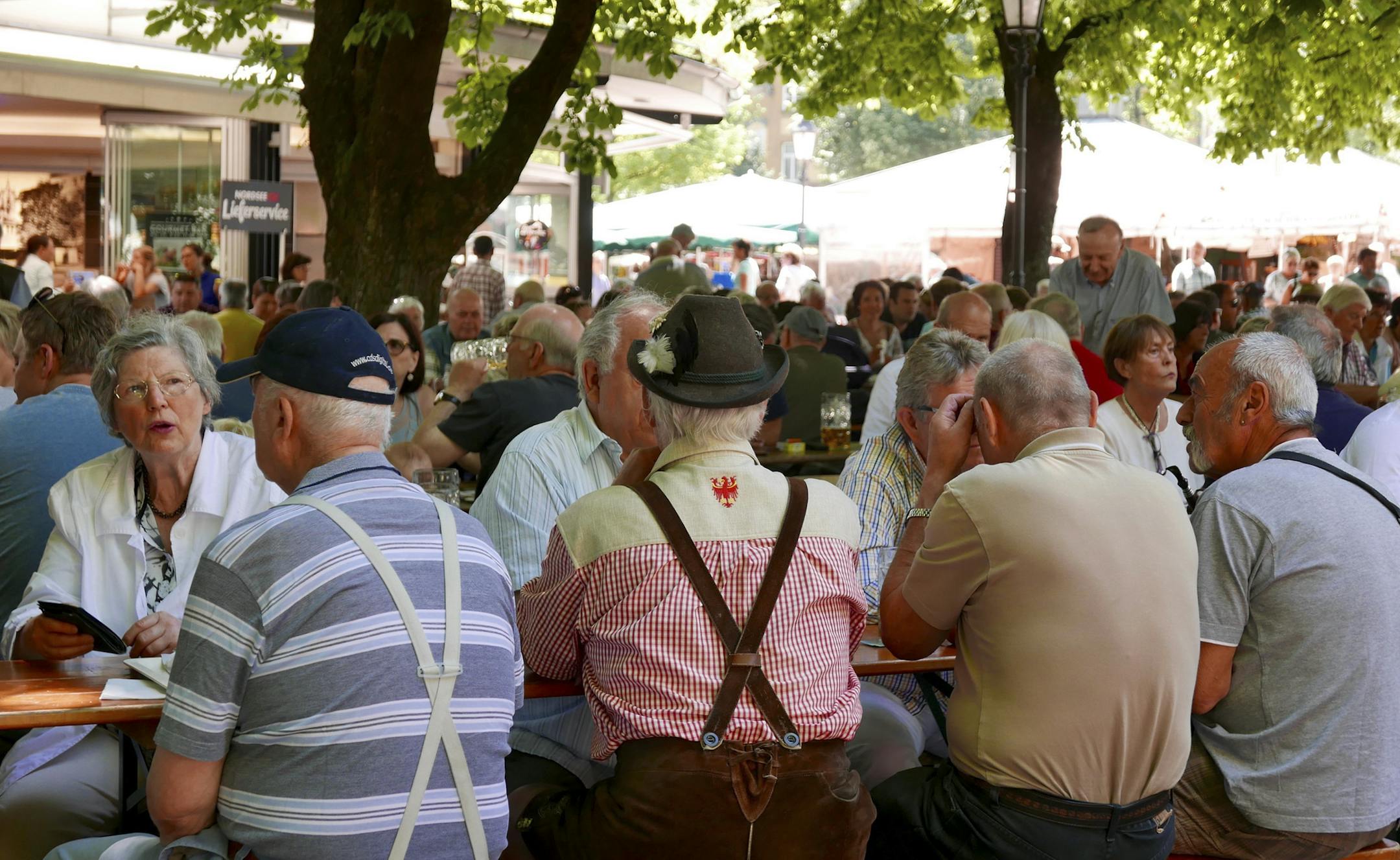 Locals picnic at Viktualienmarkt, where flowers, cheese, sausages and souvenirs are for sale.