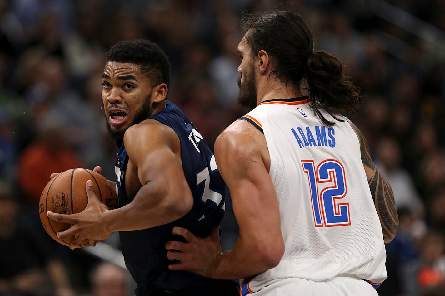 Minnesota Timberwolves center Karl-Anthony Towns (32) drove to the basket around Oklahoma City Thunder center Steven Adams (12) last season.