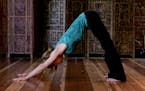 Christine Burke, co-founder of Liberation Yoga in Los Angeles, California, demonstrates the downward-facing dog pose done correctly on March 24, 2010.