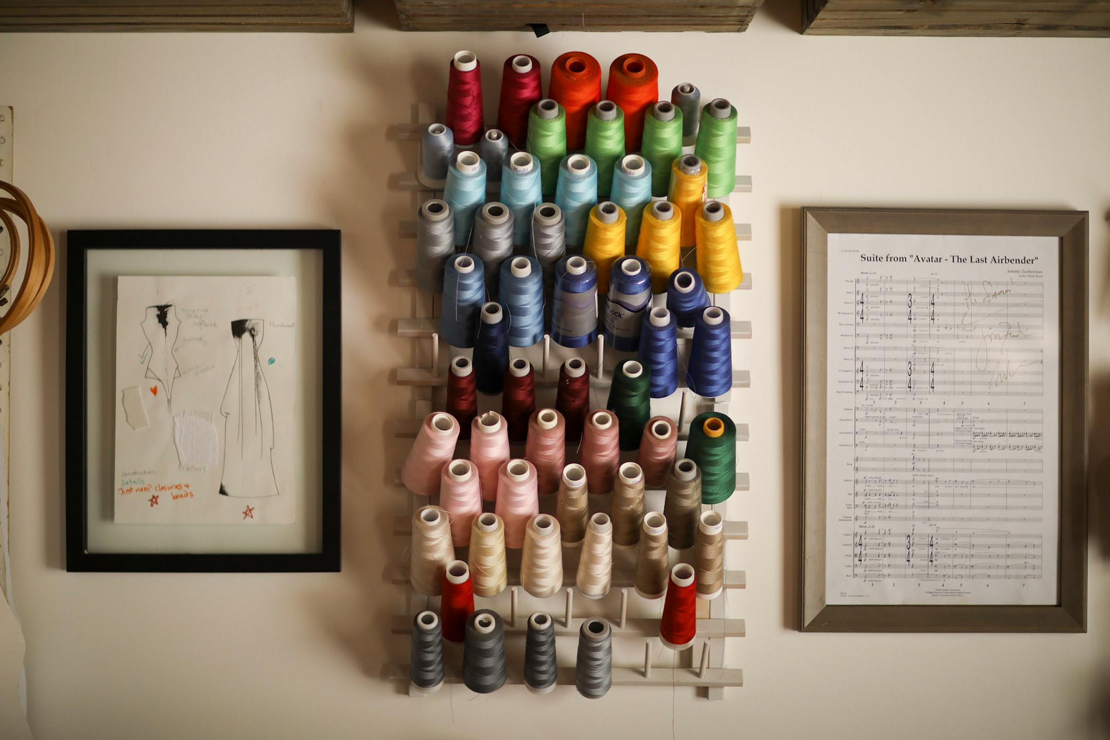 Spools of thread on a rack in the studio of Minneapolis designer Samantha Rei.