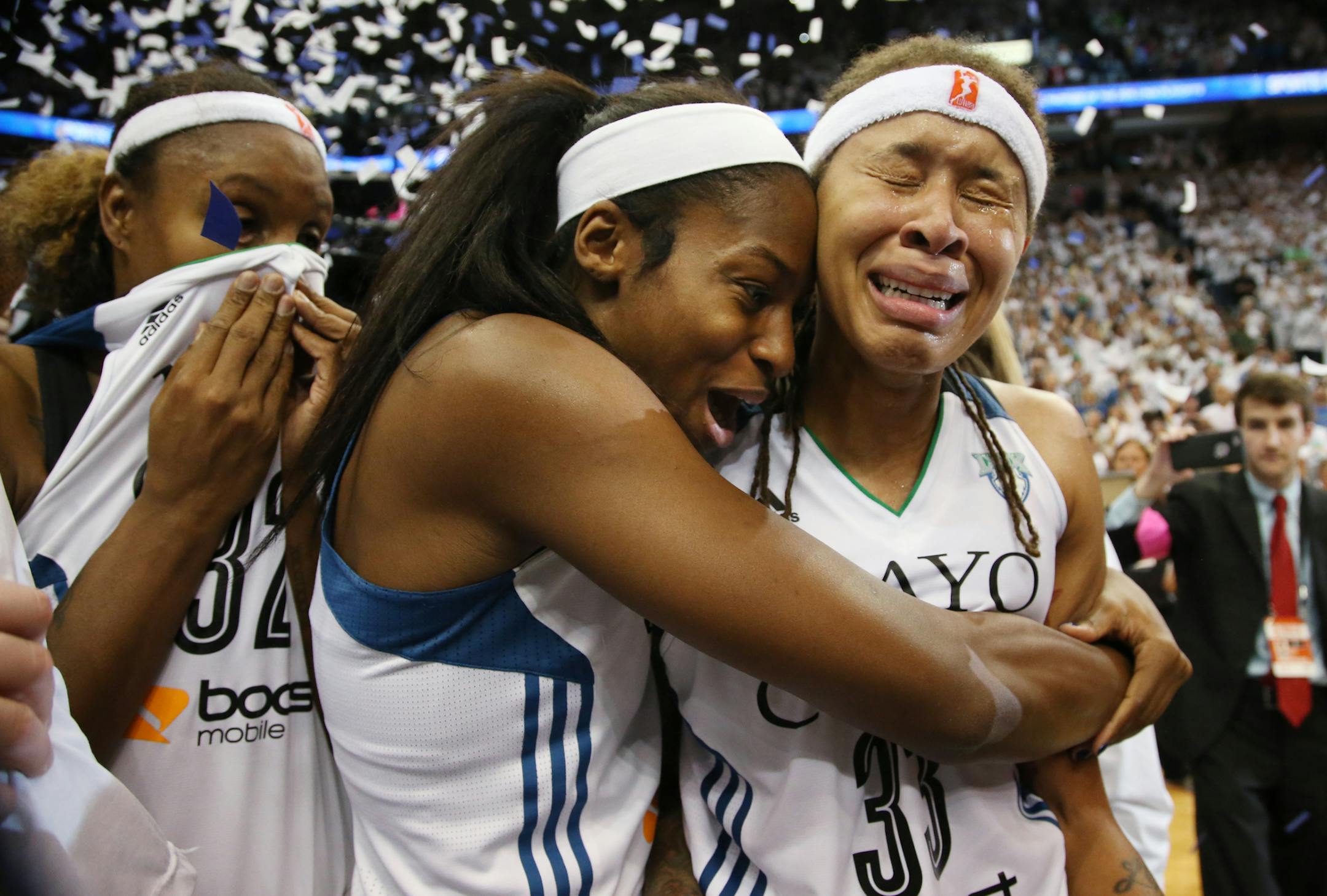 Minnesota Lynx guard Seimone Augustus (33), right, and Minnesota Lynx forward Devereaux Peters (14) celebrate winning the WNBA title. ] (KYNDELL HARKNESS/STAR TRIBUNE) kyndell.harkness@startribune.com Game 5 of the WNBA finals Lynx vs Indiana at the Target Center in Minneapolis, Min., Wednesday October 14, 2015. ORG XMIT: MIN1510142135070441