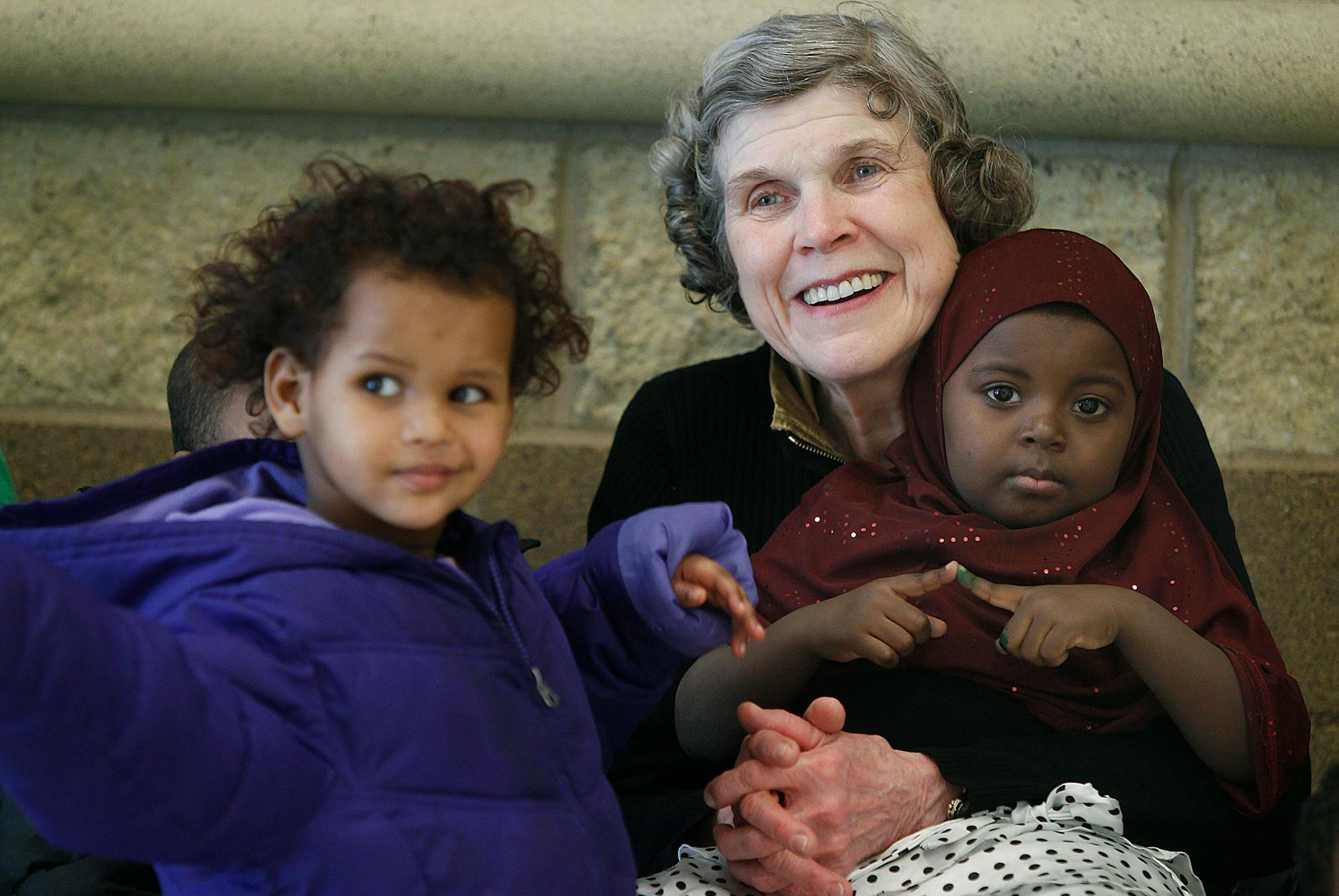 Mary Jo Copeland greeted residents with hugs and kisses including Ayan Ahmed, 3, left, and Nasib Ali, 3, at Sharing and Caring Hands Friday, February 8, 2013 near downtown Minneapolis. Copeland will receive a prestigious civilian award from President Barack Obama next week.