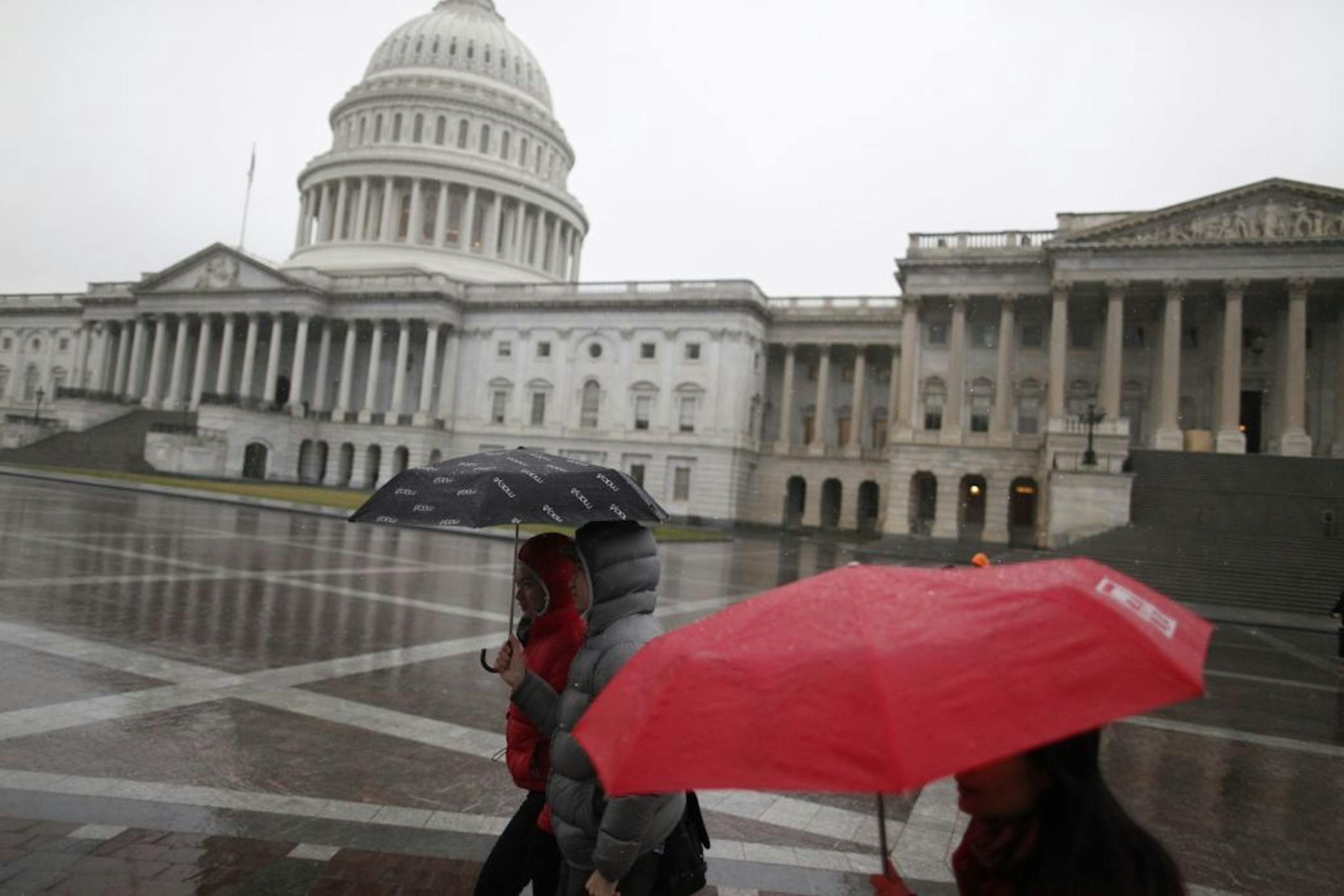 Pedestrians walk past the U.S. Capitol in Washington, Dec. 29, 2012. President Barack Obama urged Congress on Saturday to find a last-minute solution to avert a fiscal crisis that would begin Jan. 1.