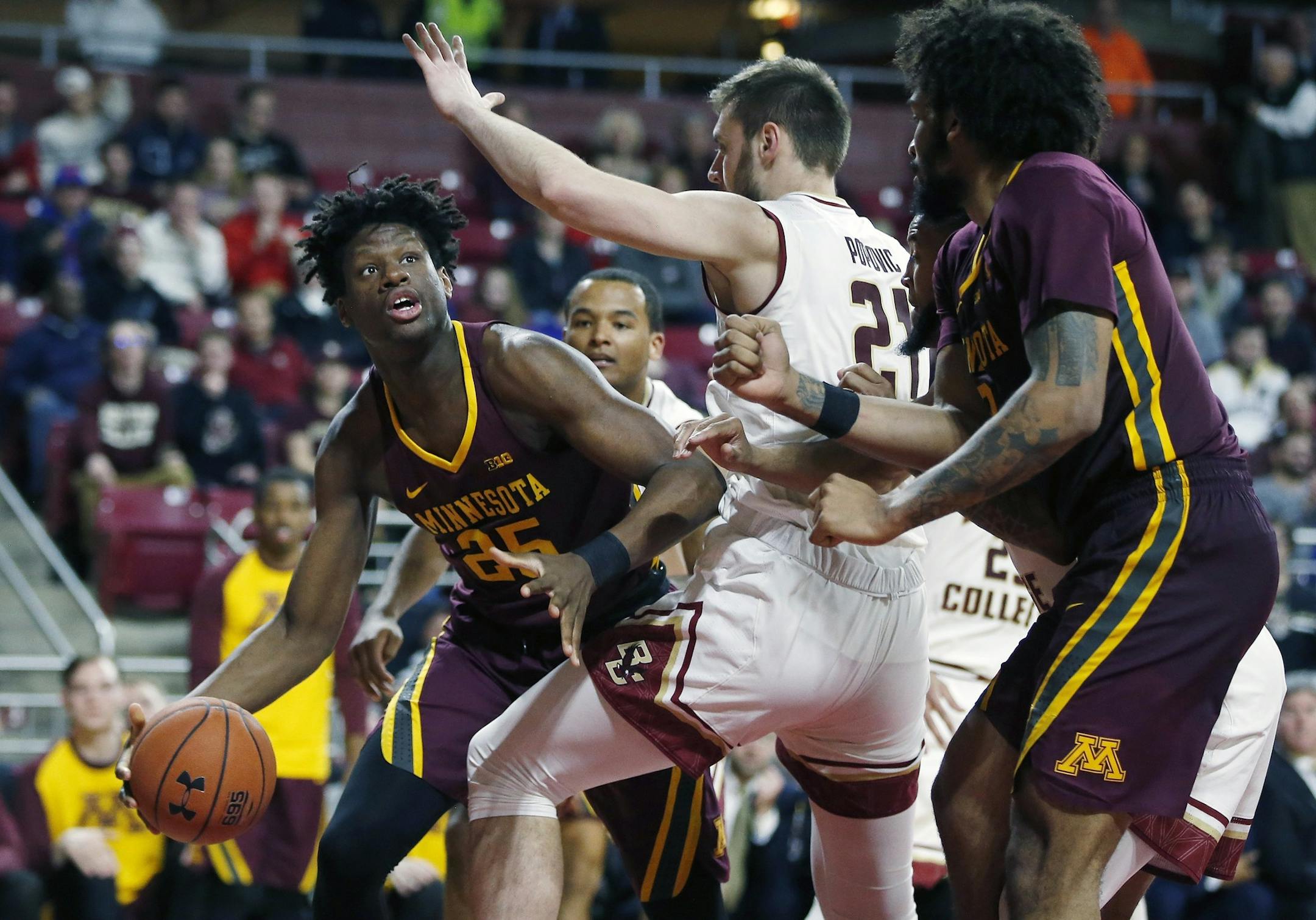 Minnesota's Daniel Oturu (25) looks to shoot against Boston College's Nik Popovic (21) during the second half of an NCAA college basketball game in Boston, Monday, Nov. 26, 2018. (AP Photo/Michael Dwyer)