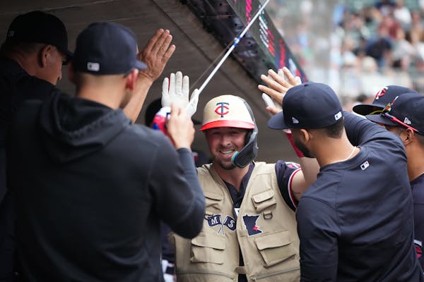 Kyle Farmer wore the Twins home run vest and celebrated with teammates after his fourth-inning home run.