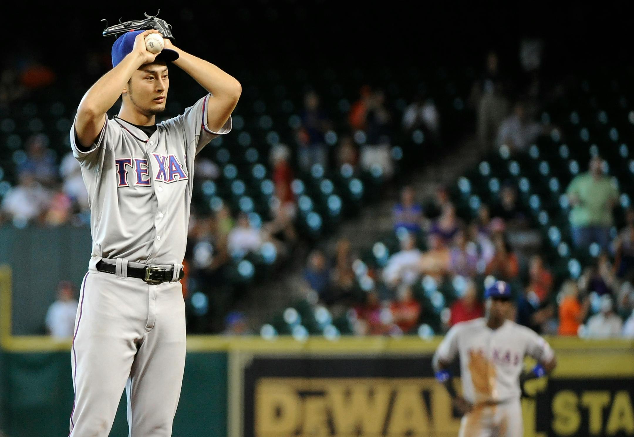 Rangers pitcher Yu Darvish reacted to giving up a solo homer to Houston's Carlos Corporan that ruined his no-hitter in the eighth inning Monday. Texas won 2-1.