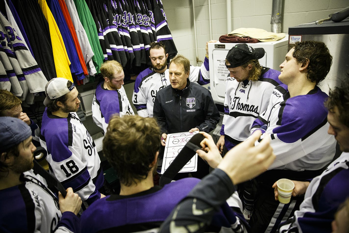 Head Coach Jeff Boeser draws up plays for his team in an equipment room in a period break during the MIAC Championship hockey game against Gustavus Adolphus College at the St. Thomas Ice Arena in Mendota Heights on March 8, 2014. The Tommies won the game and the MIAC Championship title by a final score of 2-1.