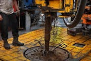 The drilling rig floor is slick with grease and oil.] (JIM GEHRZ/STAR TRIBUNE) / December 17, 2013, Watford City, ND &#x201a;&#xc4;&#xec; BACKGROUND I