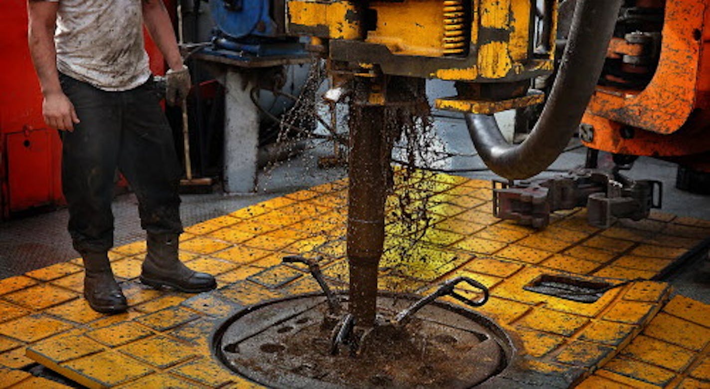 The drilling rig floor is slick with grease and oil.] (JIM GEHRZ/STAR TRIBUNE) / December 17, 2013, Watford City, ND &#x201a;&#xc4;&#xec; BACKGROUND INFORMATION- PHOTOS FOR USE IN FINAL PART OF NORTH DAKOTA OIL BOOM PROJECT: Men work around the clock at Raven Rig No. 1 near Watford City, one of nearly 200 towering oil rigs in the Bakken. Once the rigs drill holes, several miles deep and then several miles horizontally, hydraulic fracturing technology (&#x201a;&#xc4;&#xfa;fracking&#x201a;&#xc4;&#