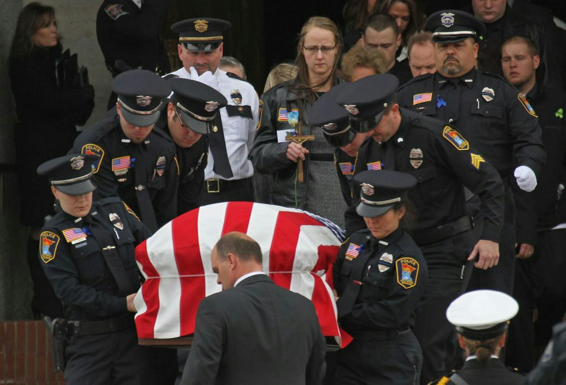 The casket of Cold Spring police officer Thomas Decker is carried from St. John's Abbey and University Church at St. John's University in Collegeville, Minn. Wednesday, Dec. 5, 2012. Decker, 31, was fatally shot last Thursday when he was called to check on a man�s welfare. No charges have been filed in his death. (AP Photo/The Star Tribune, Bruce Bisping) MANDATORY CREDIT; ST. PAUL PIONEER PRESS OUT; MAGS OUT; TWIN CITIES TV OUT