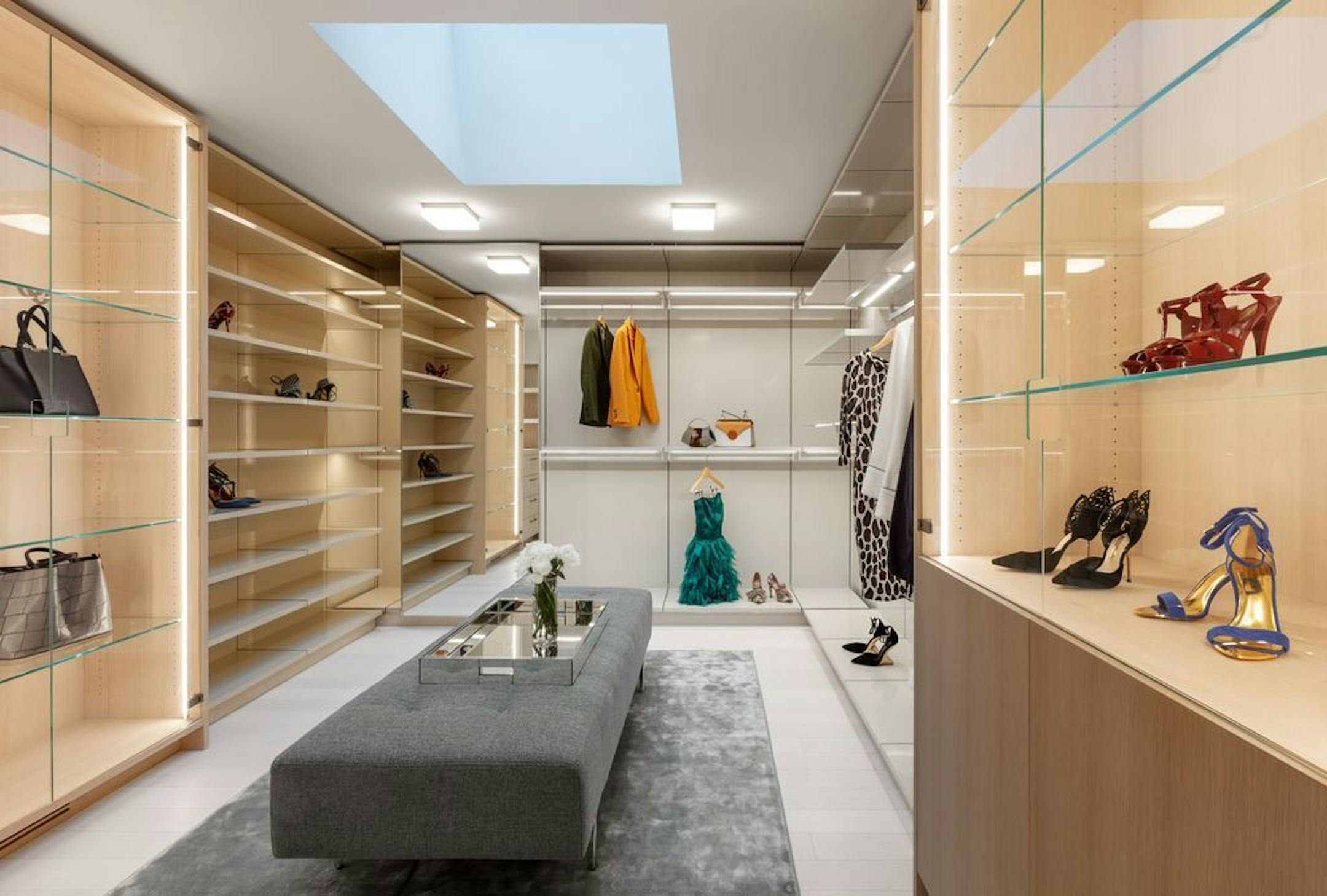 A closet in the owners' suite includes a skylight, built-in bench and display storage.