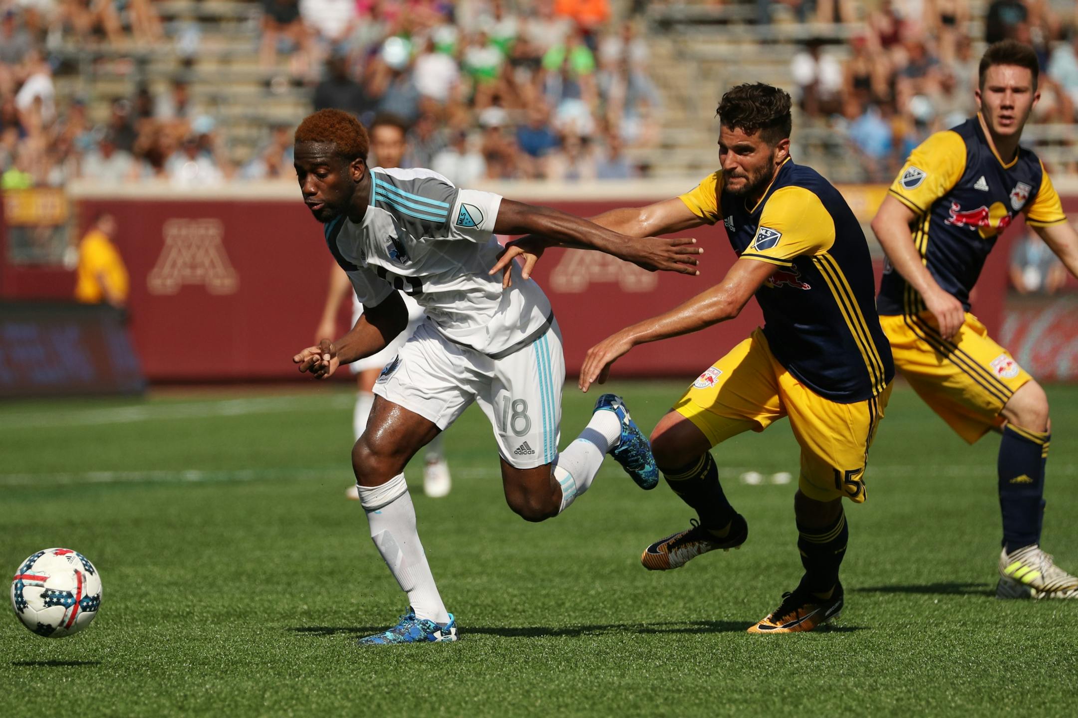 New York Red Bulls midfielder Alex Muyl (19) looked on as New York Red Bulls midfielder Salvatore Zizzo (15) tried to take the ball from Minnesota United midfielder Kevin Molino (18) while he dribbled down field in the second half.