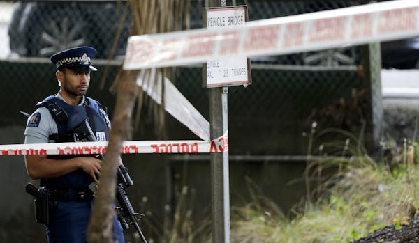 A police officer guard near the Masjid Al Noor mosque, site of one of the mass shootings at two mosques in Christchurch, New Zealand, Saturday, March 