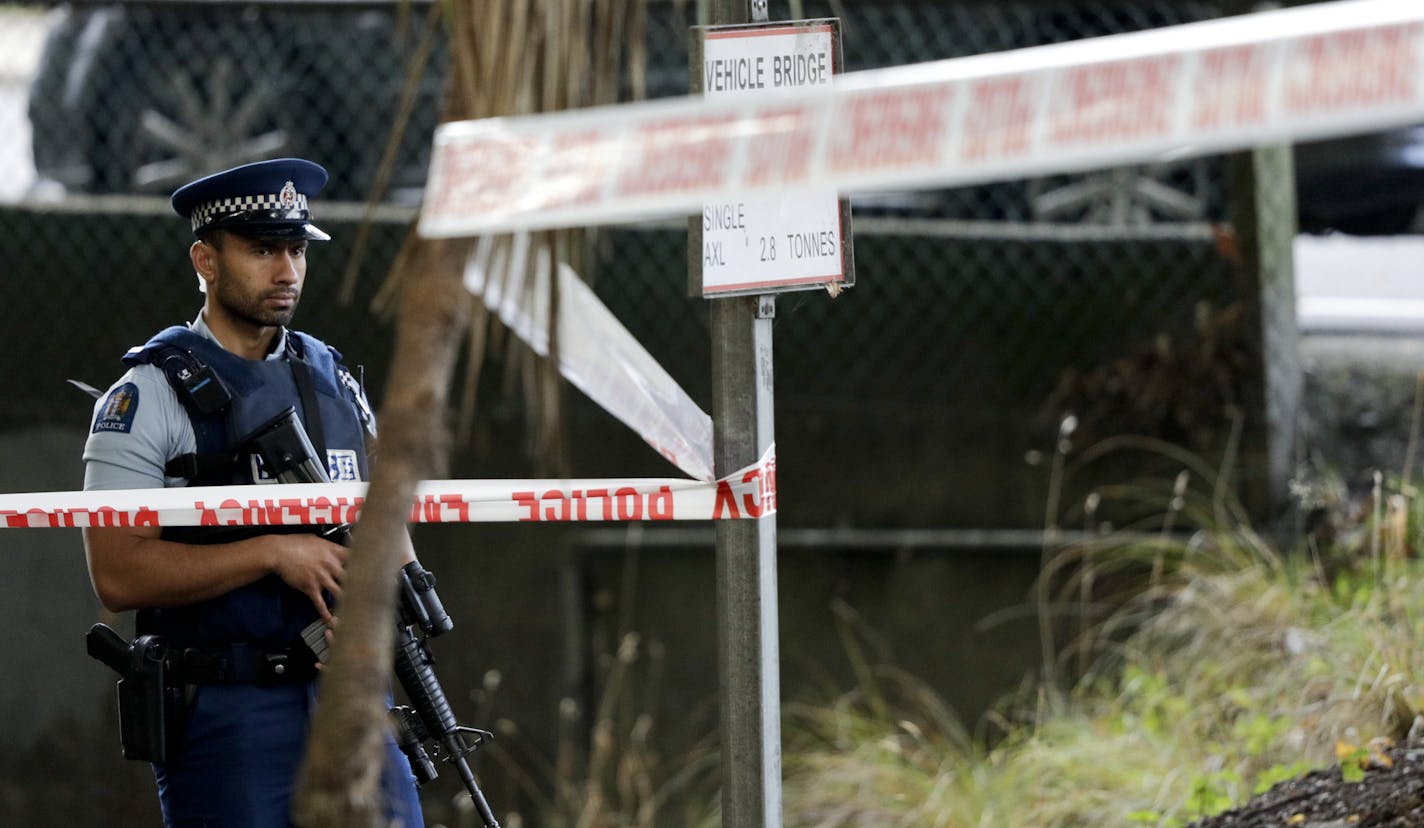 A police officer guard near the Masjid Al Noor mosque, site of one of the mass shootings at two mosques in Christchurch, New Zealand, Saturday, March 16, 2019. (AP Photo/Mark Baker)