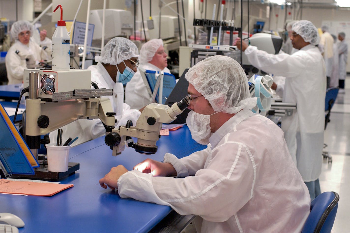 Researchers work in a clean room at the Boston Scientific Cardiovascular research and development center in Maple Grove, Minn.