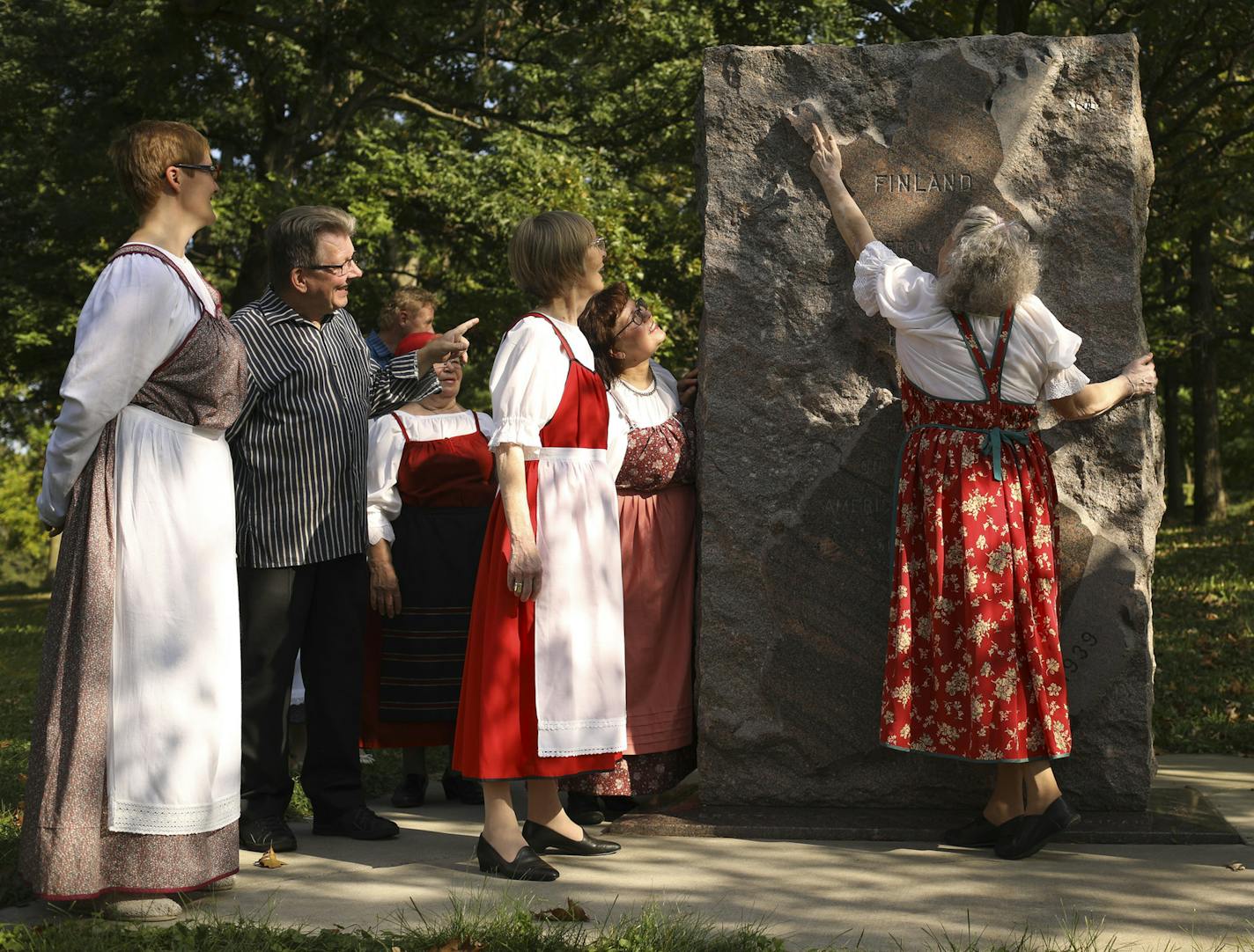 Tuire Hindikka pointed to a spot on the map of Finland on the monument for other members of her goup, Theatre Fiasko from Joensuu, Finland Thursday afternoon. The group recited two poems that spoke to the character of the Finnish people during the kickoff event. Truth be told, she is showing the others the remote region where her ex-husband lives now. ] JEFF WHEELER &#xef; jeff.wheeler@startribune.com U.S. events to commemorate the 100th anniversary of Finland's independence, were kicked off at