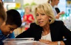 Education Secretary Betsy DeVos tours the Van Andel Institute where students in the Cohort Program were studying in Grand Rapids, Mich., on Tuesday, A