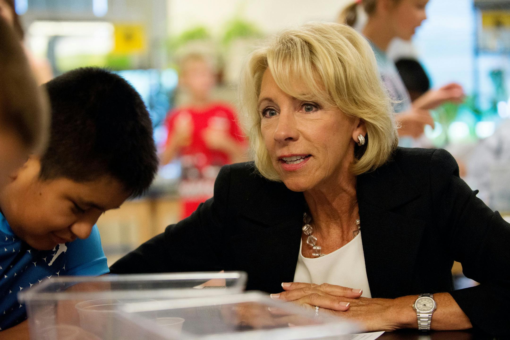 Education Secretary Betsy DeVos tours the Van Andel Institute where students in the Cohort Program were studying in Grand Rapids, Mich., on Tuesday, Aug. 1, 2017. DeVos took questions from the students that ranged from her favorite color to her stance on transportation and schools of choice. (Neil Blake /The Grand Rapids Press via AP)