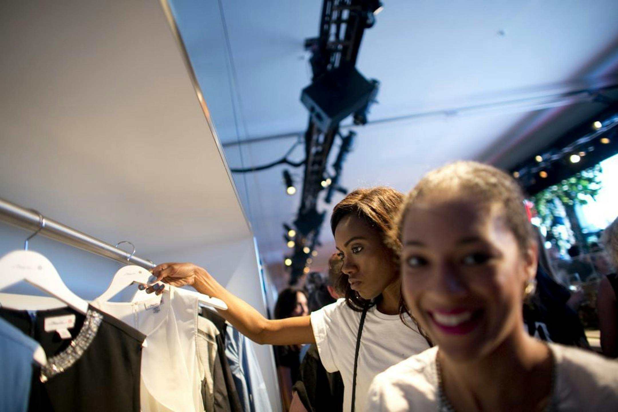 Shoppers browse racks at Phillip Lim's Target collection launch event on the first day of Mercedes-Benz Fashion Week in New York, Sept. 5, 2013. Fashion week runs through Sept. 12.