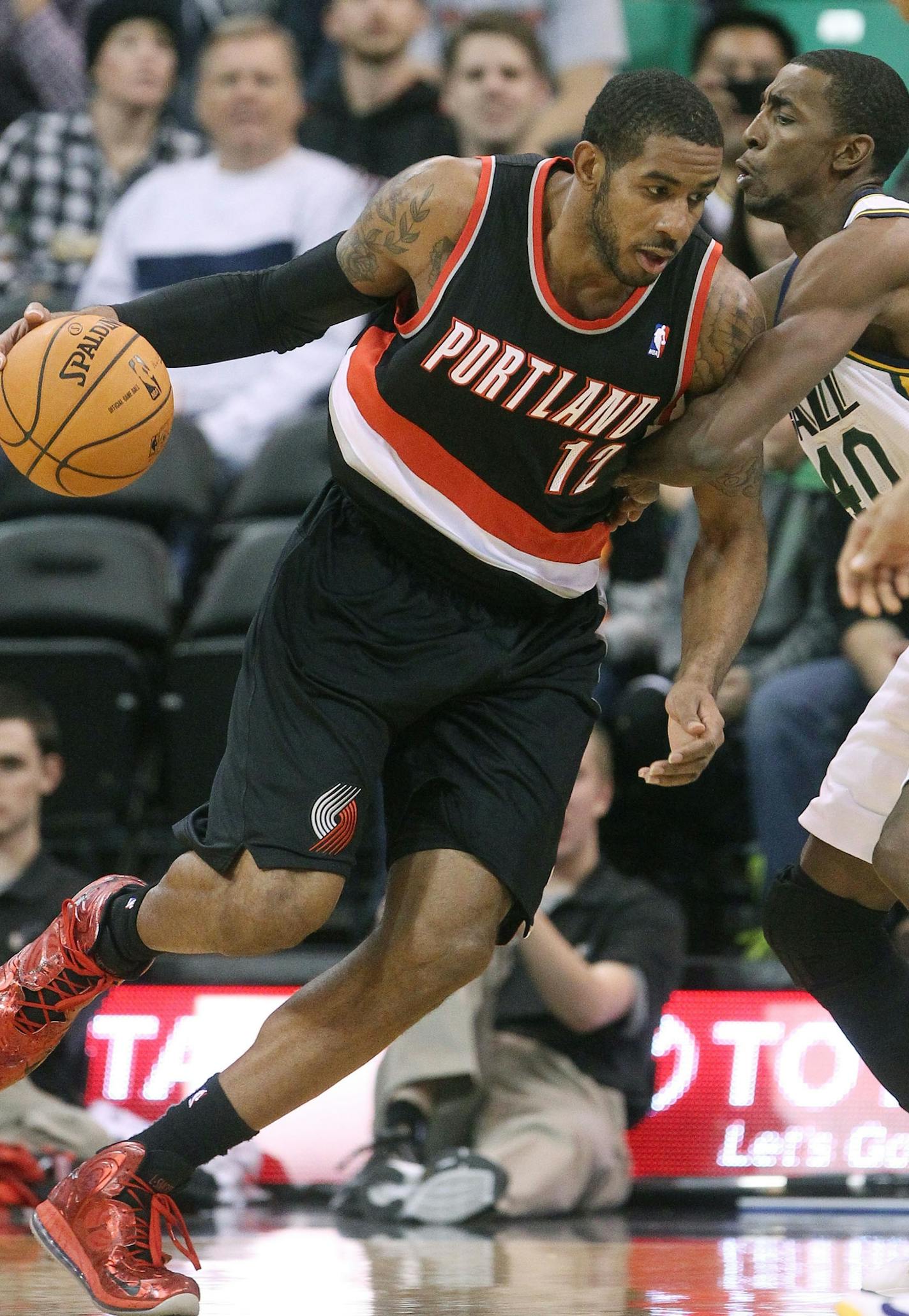 Portland Trail Blazers' LaMarcus Aldridge (12) drives on Utah Jazz's Jeremy Evans, right, in the first quarter during an NBA basketball game Monday, Dec. 9, 2013, in Salt Lake City. (AP Photo/Rick Bowmer)