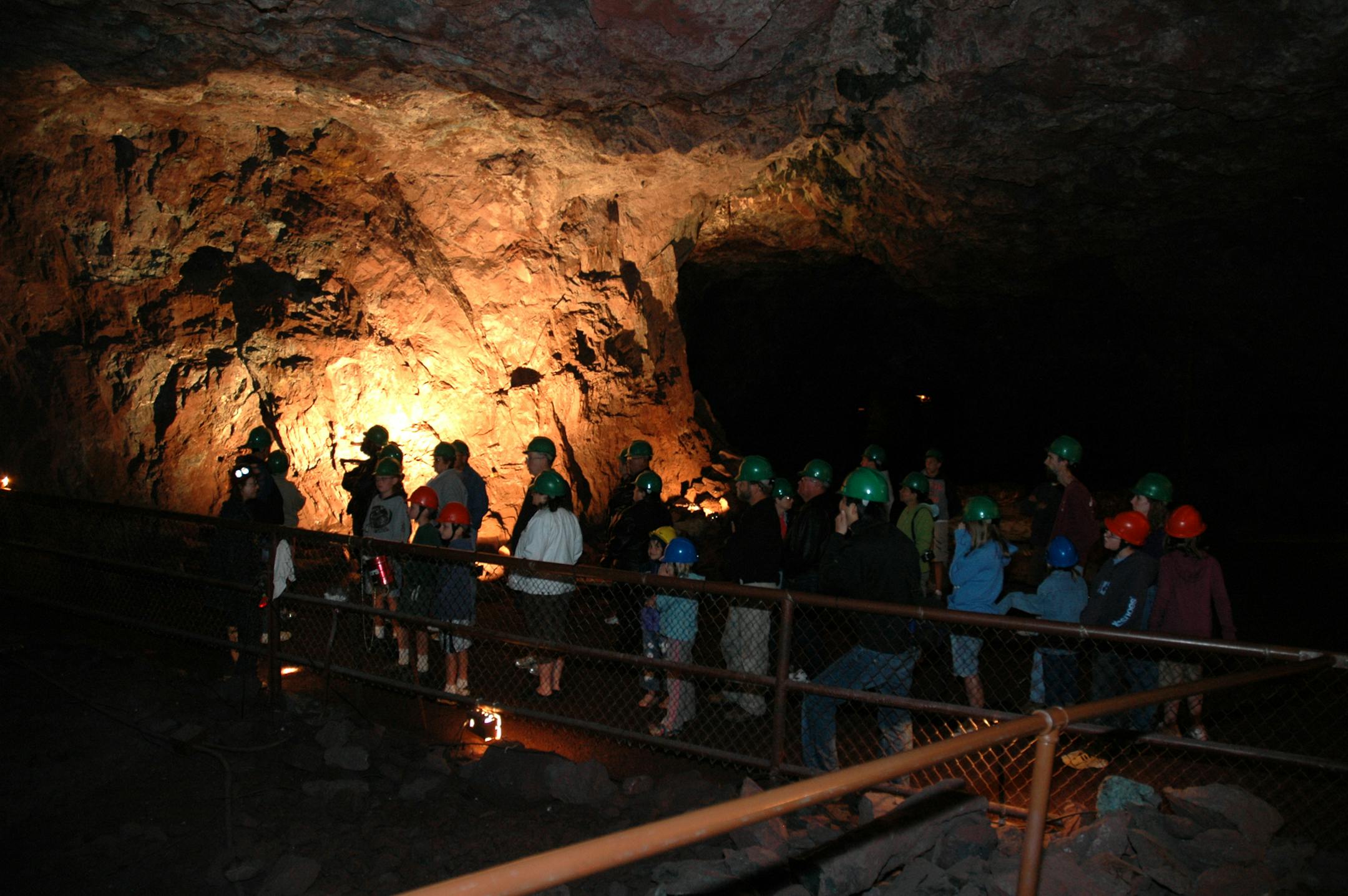 A guide leads visitors through the old Soudan iron mine, located a half mile underground.