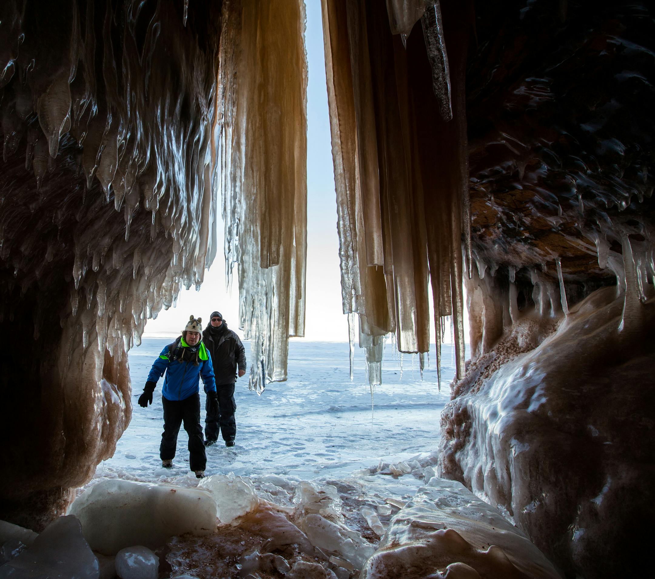 Edward Mitchell, front, of Detroit, and James Kuhn, of Seattle, explore an ice cave at the Apostle Islands National Lakeshore on Lake Superior, Friday, Feb. 27, 2015, near Bayfield, Wis. (Zbigniew Bzdak/Chicago Tribune) ORG XMIT: MIN2015022715523917
