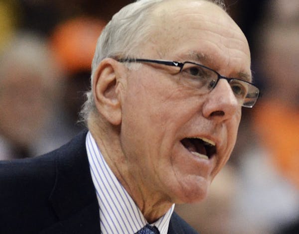 Syracuse head coach Jim Boeheim, left, talks with Ron Patterson during a timeout against Fordham during the second half of an NCAA college basketball 