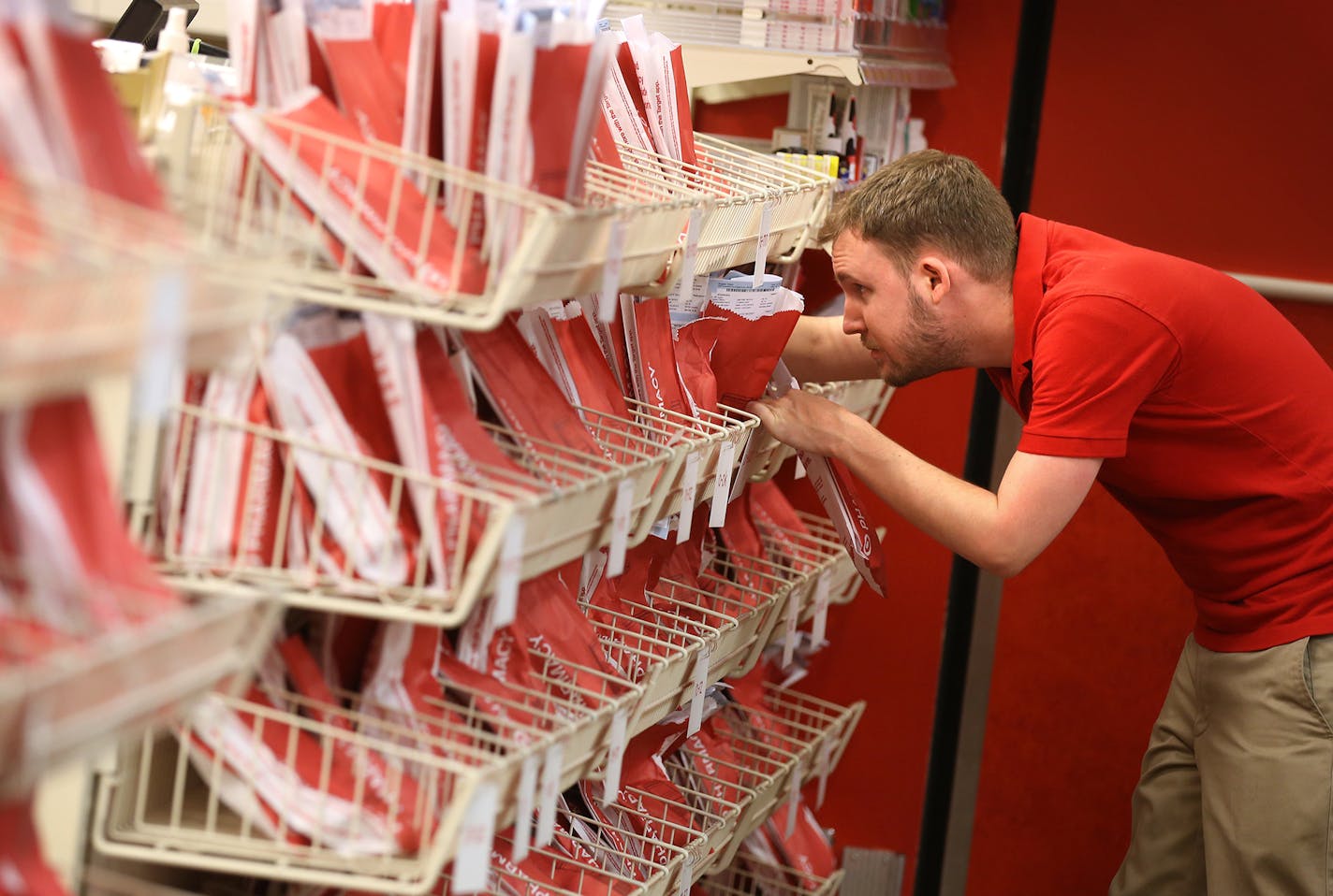 Pharmacy technician Curt Doeden looks for prescriptions at the pharmacy inside the Target in downtown Minneapolis on Monday, June 15, 2015. ] LEILA NAVIDI leila.navidi@startribune.com / BACKGROUND INFORMATION: Target has sold its 1,660 pharmacies and 80 in-store clinics to CVS in a $1.9 billion deal.