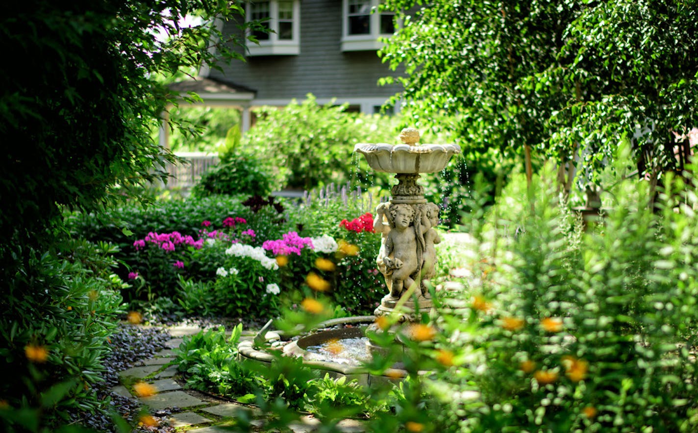 Beautiful Gardens winners Mark Addicks and Tom Hoch who tend a secluded backyard garden at their Lowry Hill home. ] GLEN STUBBE * gstubbe@startribune.com Friday, July 15, 2016 Beautiful Gardens winners Mark Addicks and Tom Hoch who tend a secluded backyard garden at their Lowry Hill home and a public garden on Lake of the Isles.