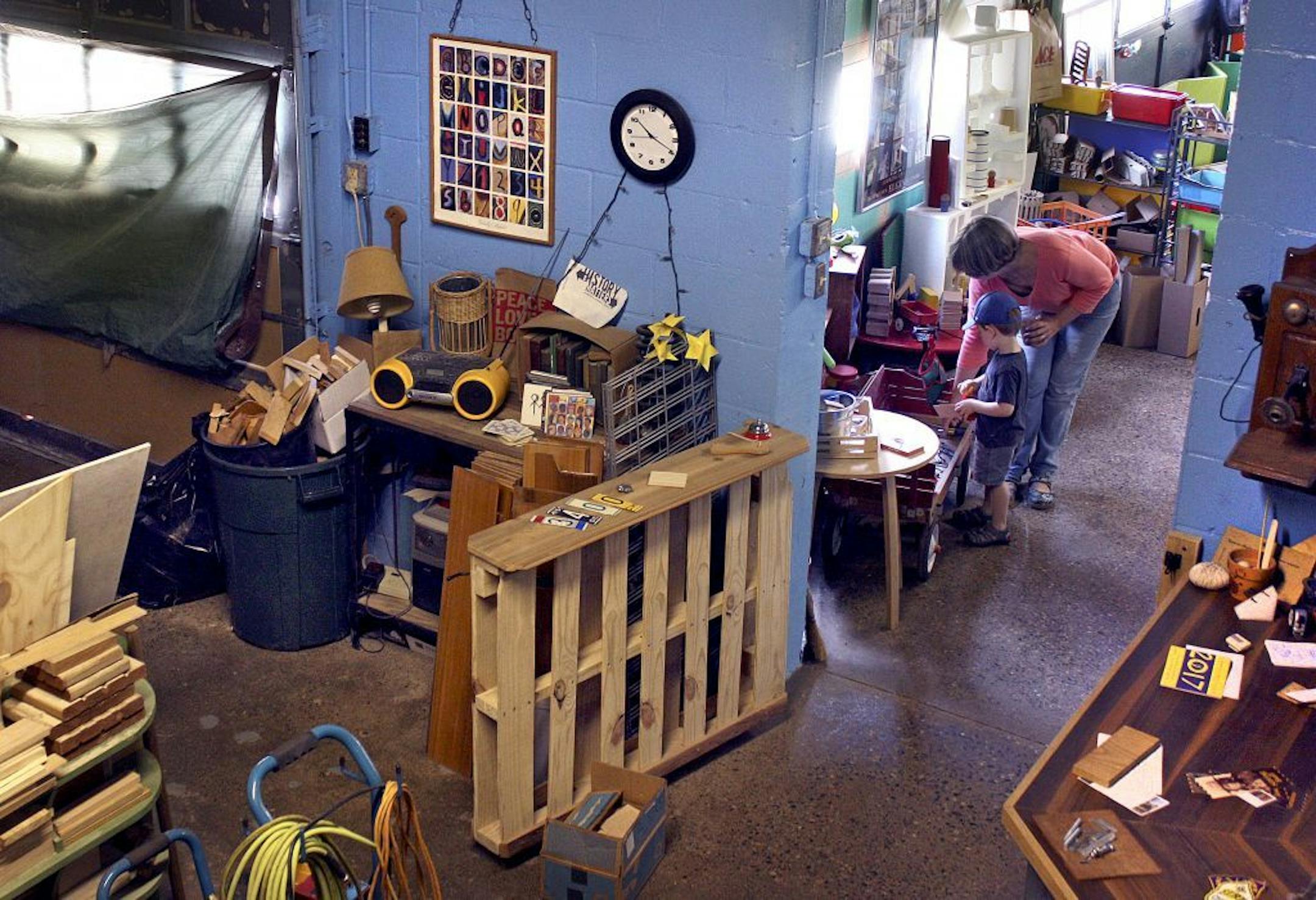 Lucy Elliott and her grandson Nels play with toys at Belle's Toy Box, a former auto garage in South Minneapolis that Elliott purchased and turned into a project and play space for families. (Sarah Jarvis, Star Tribune) ORG XMIT: MIN1708081048210788