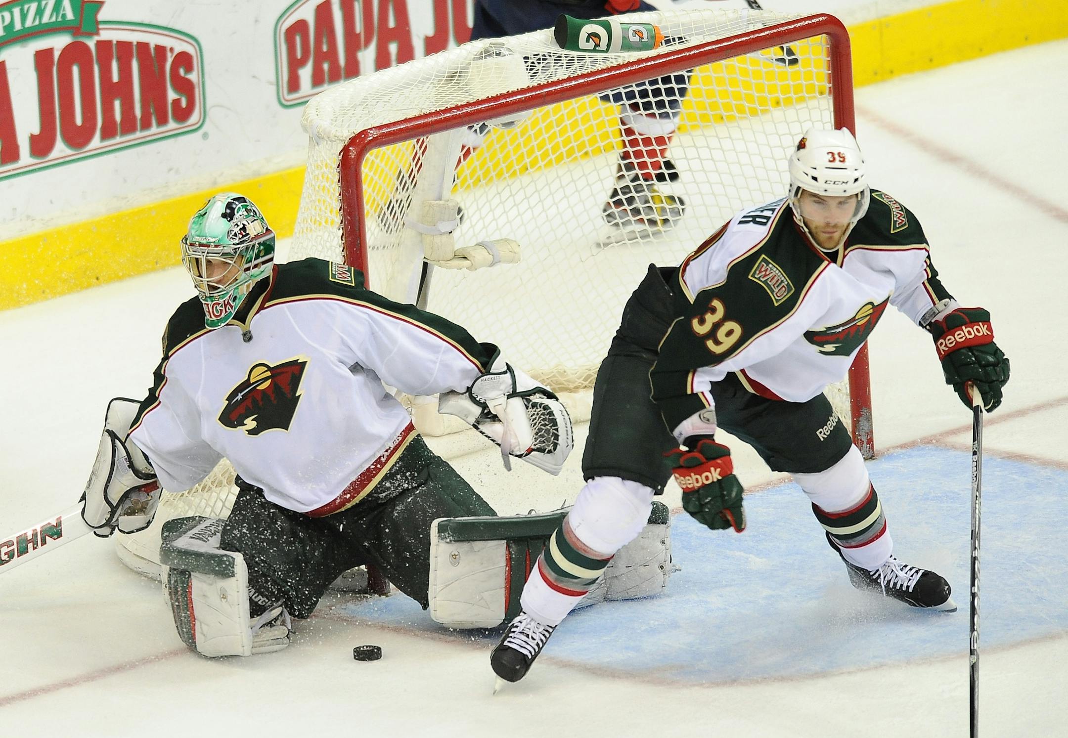 Minnesota Wild goalie Matt Hackett (31) and Wild defenseman Nate Prosser (39) search for the puck after Hackett made a save on Washington Capitals left wing Alex Ovechkin (8) in the third period at the Verizon Center in Washington, D.C., Sunday, March 25, 2012. The Capitals defeated the Wild, 3-0.
