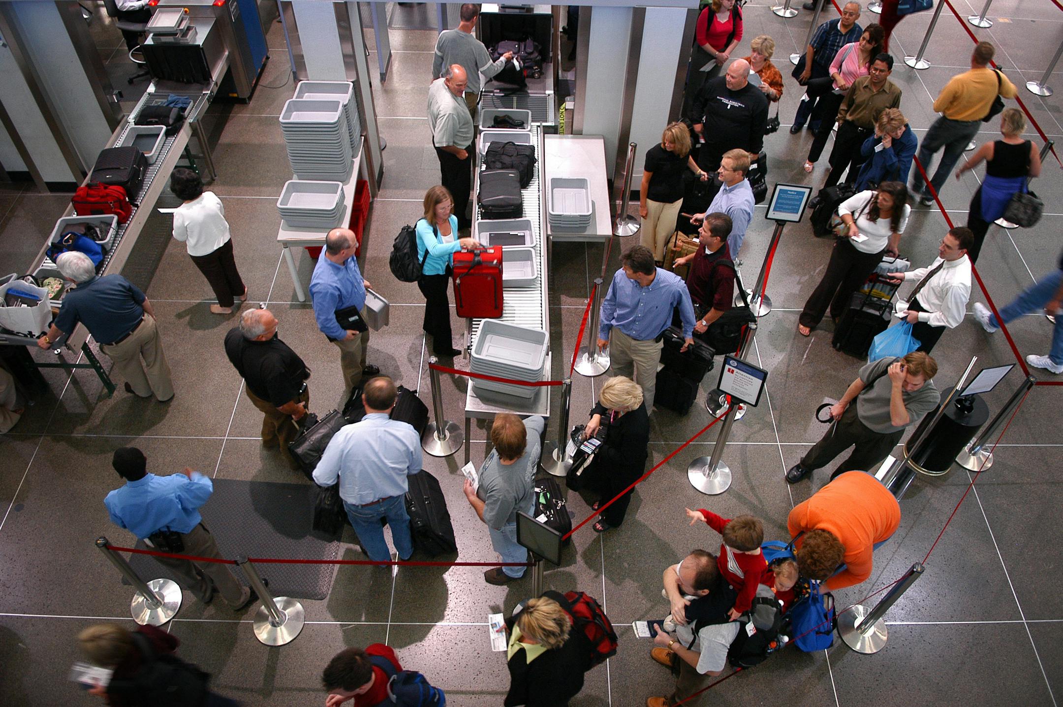 Passengers wait to check in at Minneapolis-St. Paul International Airport.