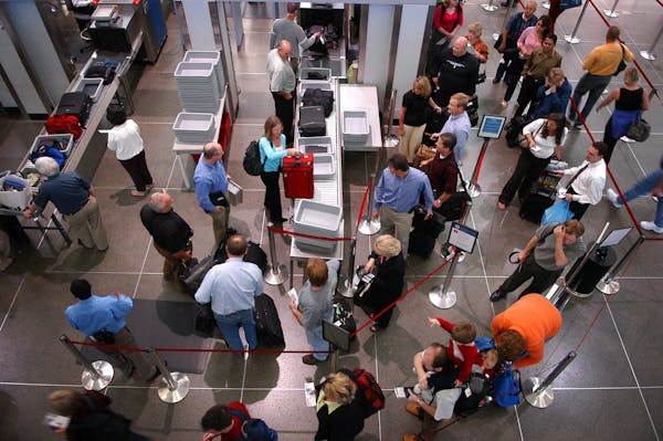 Passengers wait to check in at Minneapolis-St. Paul International Airport.