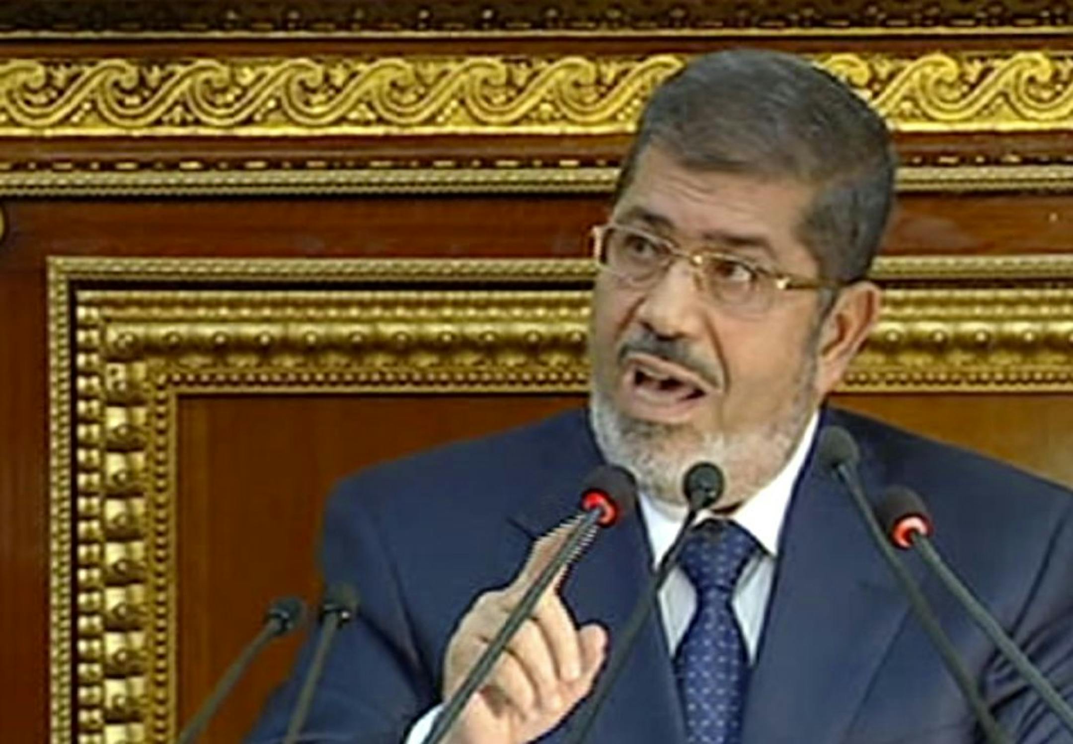 In this image made from Egyptian State Television, Egyptian President Mohammed Morsi speaks at the Shura Council, the country's upper house of parliament, in Cairo, Saturday, Dec. 29, 2012.