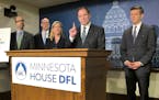 Minnesota House Tax Committee Chairman Paul Marquart, second from right, presents the House Democratic tax bill at a news conference at the state Capi
