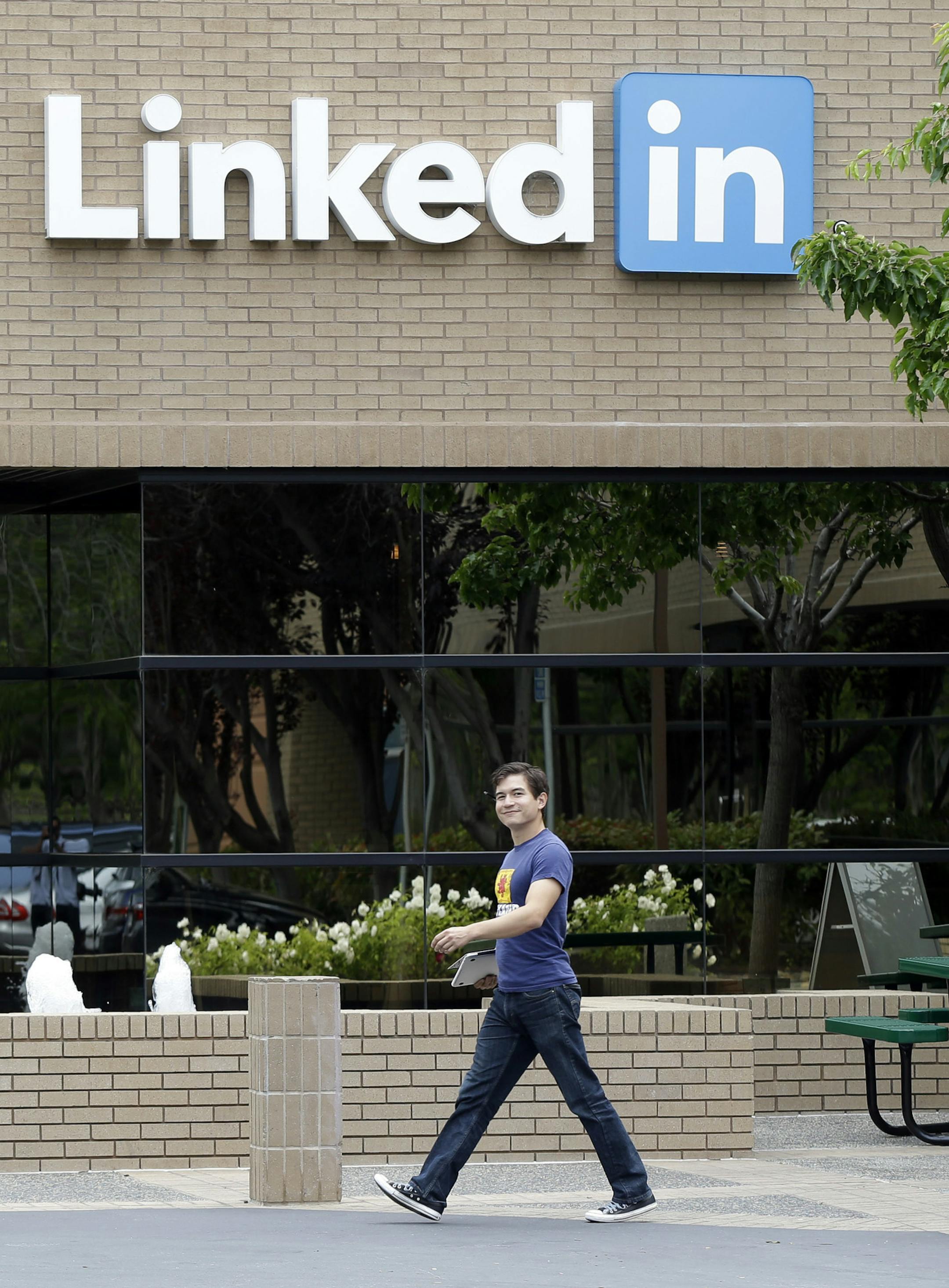 FILE - In this May 8, 2014, file photo, a man walks past the LinkedIn headquarters in Mountain View, Calif. Google and LinkedIn said July 13, 2016, that they have completed a massive land swap involving several Silicon Valley properties. (AP Photo/Marcio Jose Sanchez, File) ORG XMIT: PAPM105