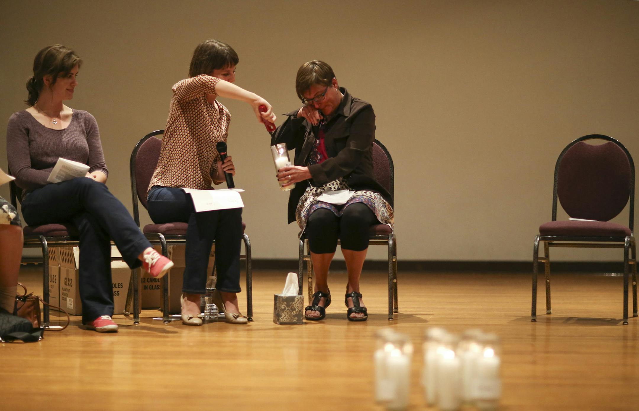 Sarah Super lit a candle held by Michele Heyer after she shared her story at the "Break the Silence Day" gathering Tuesday night in Minneapolis. All the participants who shared their experiences placed a candle at the center of the room when they were finished, 13 in all. ] JEFF WHEELER • jeff.wheeler@startribune.com Survivors of sexual violence gathered at the Ukrainian Event Center in Minneapolis Tuesday night, August 18, 2015 to speak up and out about sexual violence for "Break the Sil