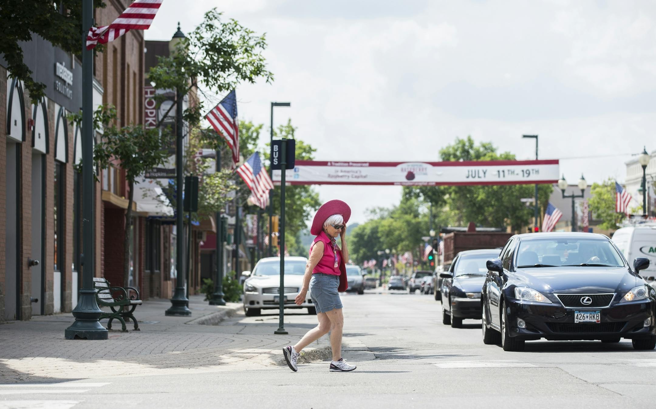 Carl Ann Carlson of Hopkins crosses Mainstreet in downtown Hopkins on Tuesday, July 14, 2015.