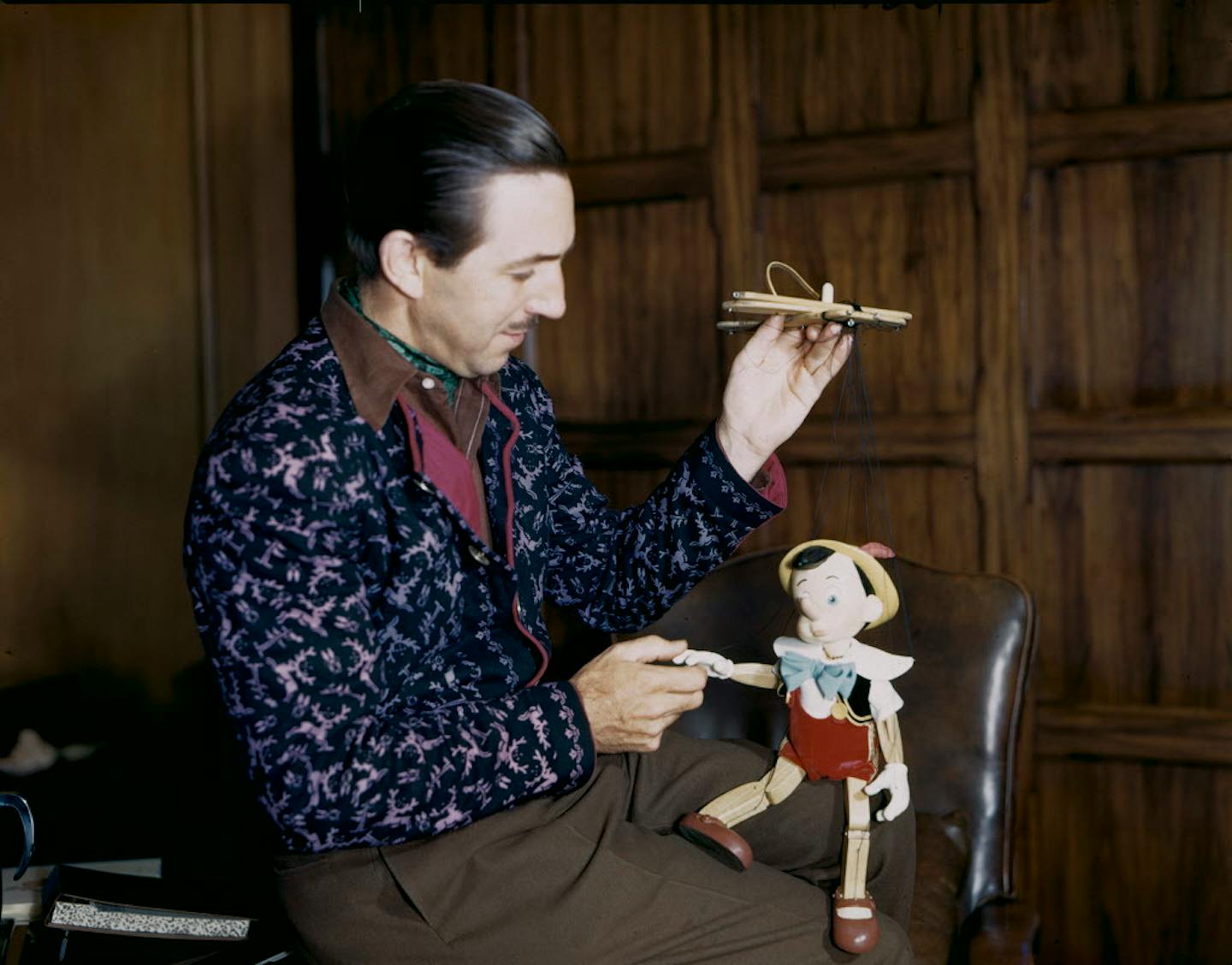 Walt Disney examined a Pinocchio marionette, circa 1939.