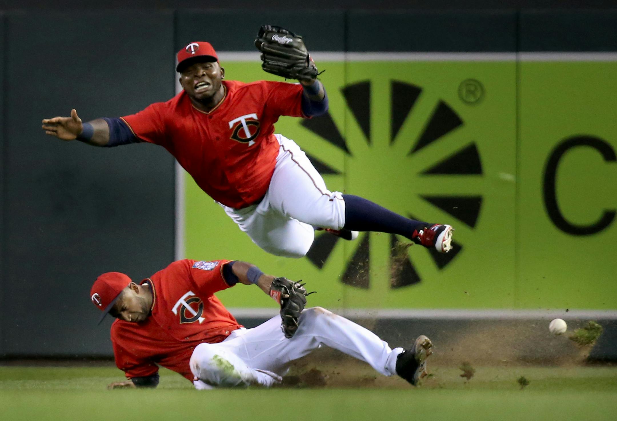 Minnesota Twins right fielder Miguel Sano, top, and second baseman Eduardo Nunez collide in right field while chasing a fly ball hit by the Los Angeles Angels' Yunel Escobar in the fourth inning on Friday, April 15, 2016, at Target Field in Minneapolis. (David Joles/Minneapolis Star Tribune/TNS)