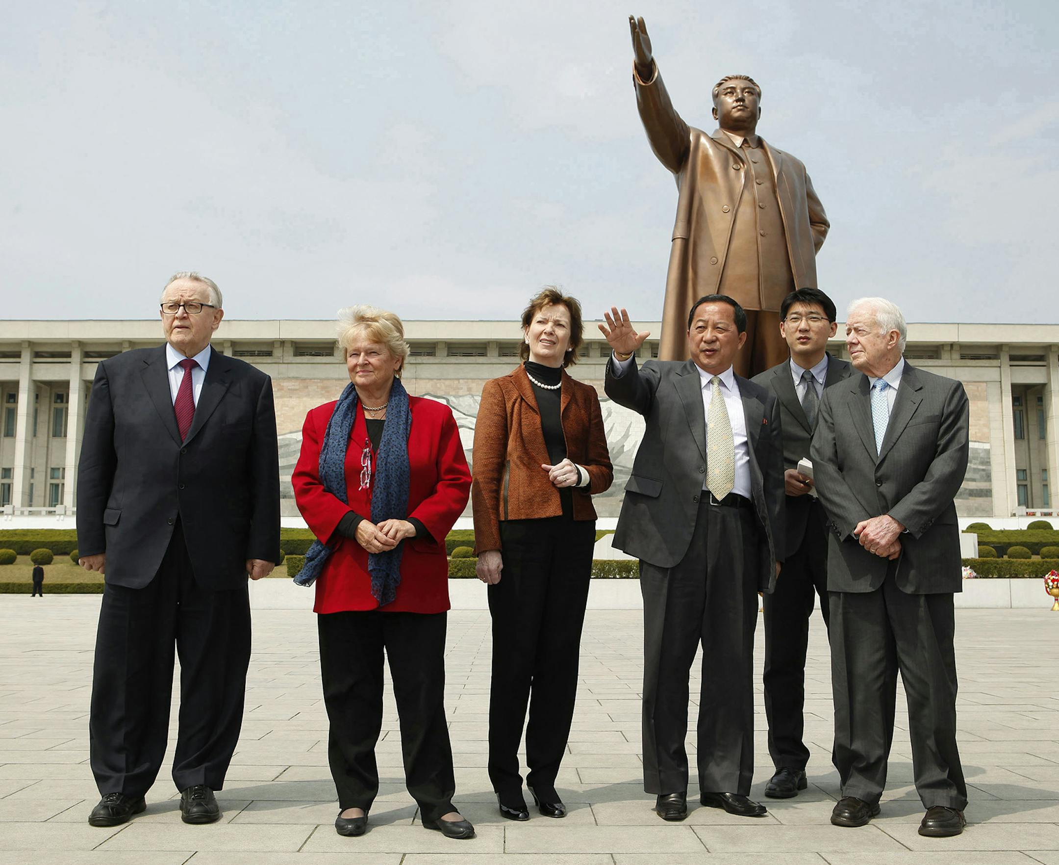 In this Tuesday, April 26, 2011 photo released from the Elders, former Finnish President Martti Ahtisaari, left to right, former Norwegian Prime Minister Gro Brundtland, former Irish Prime Minister Mary Robinson, Ri Yong Ho, vice minister of North Korean Foreign Affairs, unknown interpreter, and former U.S. President Jimmy Carter, visit the statue of the late North Korean founder Kim Il Sung in Pyongyang, North Korea. Carter, now back in Seoul from their trip to the communist country, said Thurs