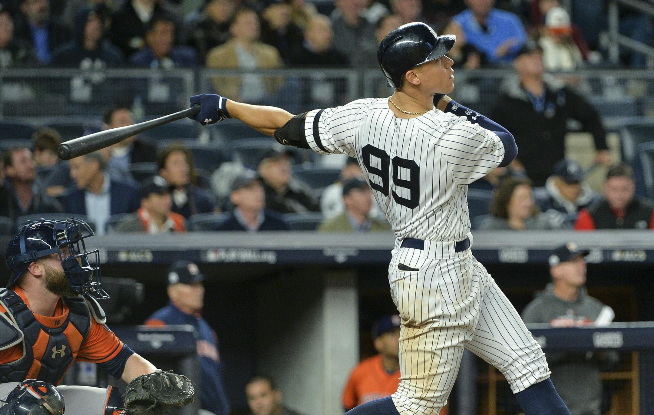 The New York Yankees' Aaron Judge, right, leads off the seventh inning with a solo home run against the Houston Astros during Game 4 of the American League Championship Series at Yankee Stadium in New York on Tuesday, Oct. 17, 2017. (Howard Simmons/New York Daily News/TNS)