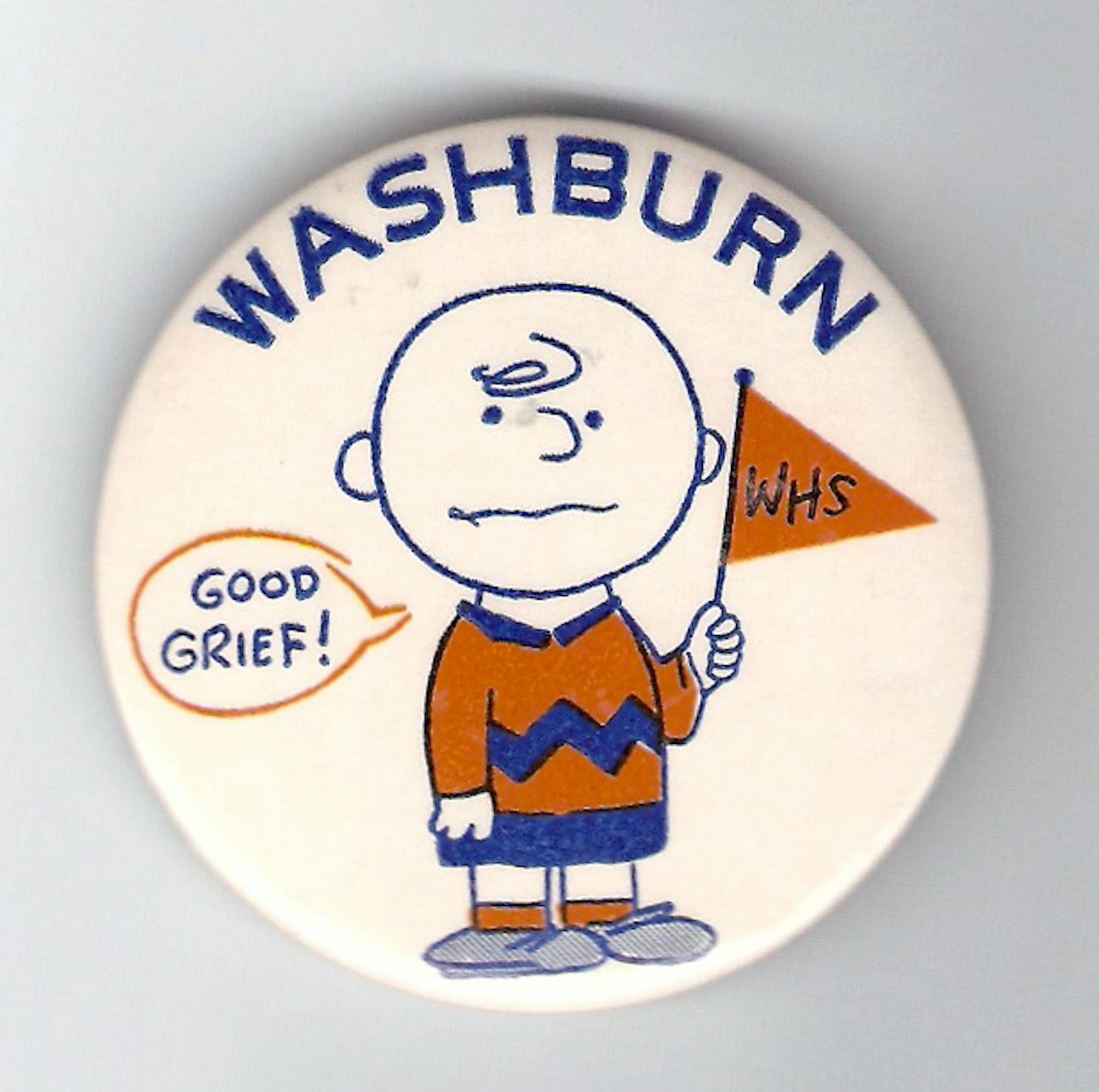 A Washburn High School homecoming button from 1958 designed by Charles Schulz.